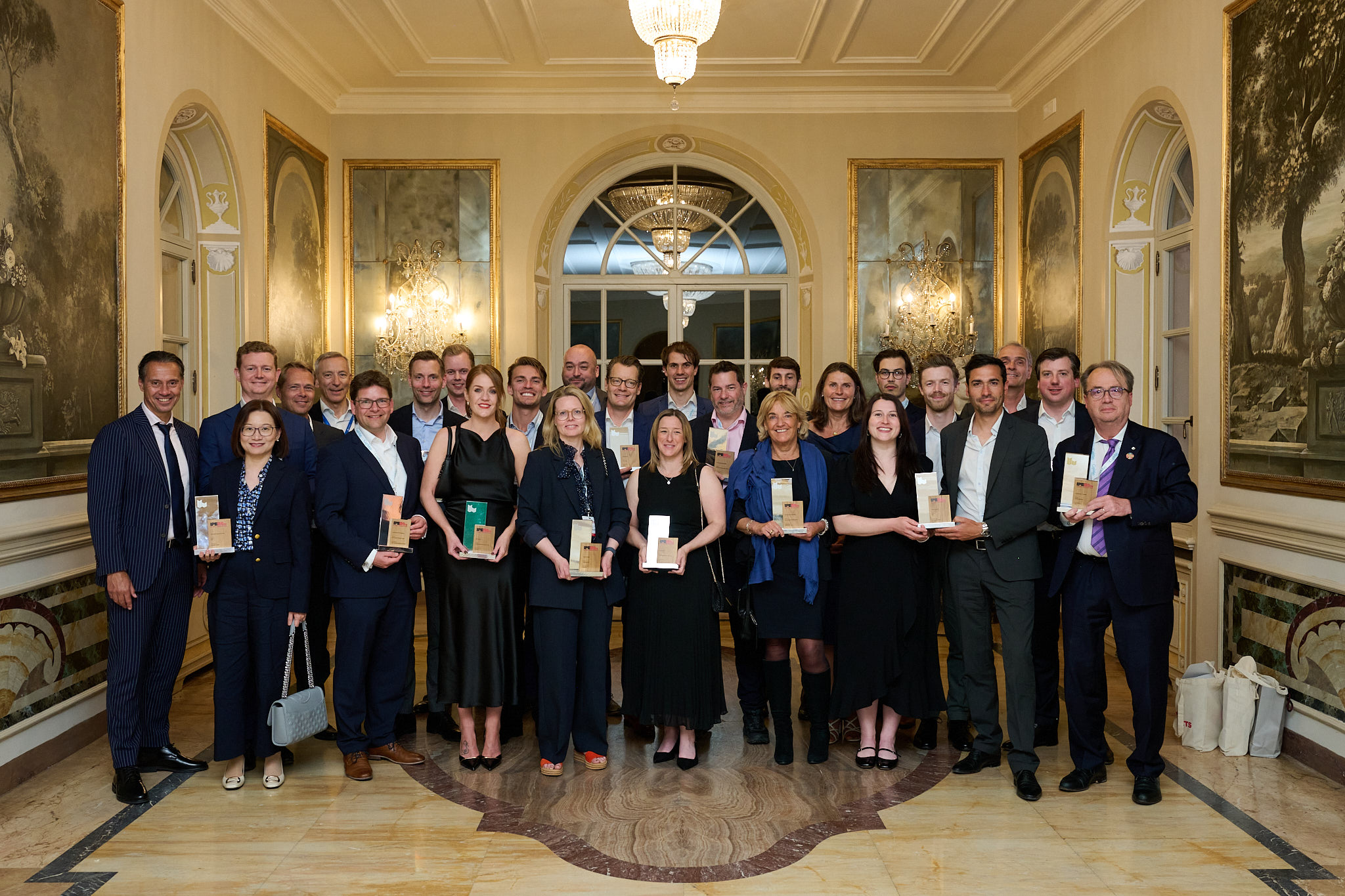 Photograph of group winners at the IPE Real Estate Global Conference 2026. A group of people holding awards including GMPF colleagues.